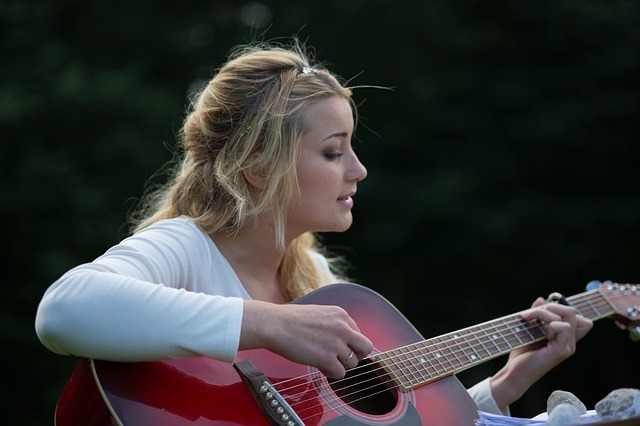 Eine junge Frau Frau beim Gitarre spielen